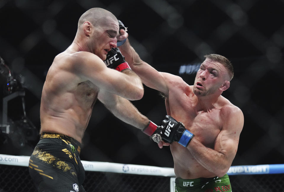 Sean Strickland, left, fights Dricus Du Plessis during a middleweight title bout during the UFC 297 mixed martial arts event in Toronto early Sunday, Jan. 21, 2024. (Nathan Denette/The Canadian Press via AP)