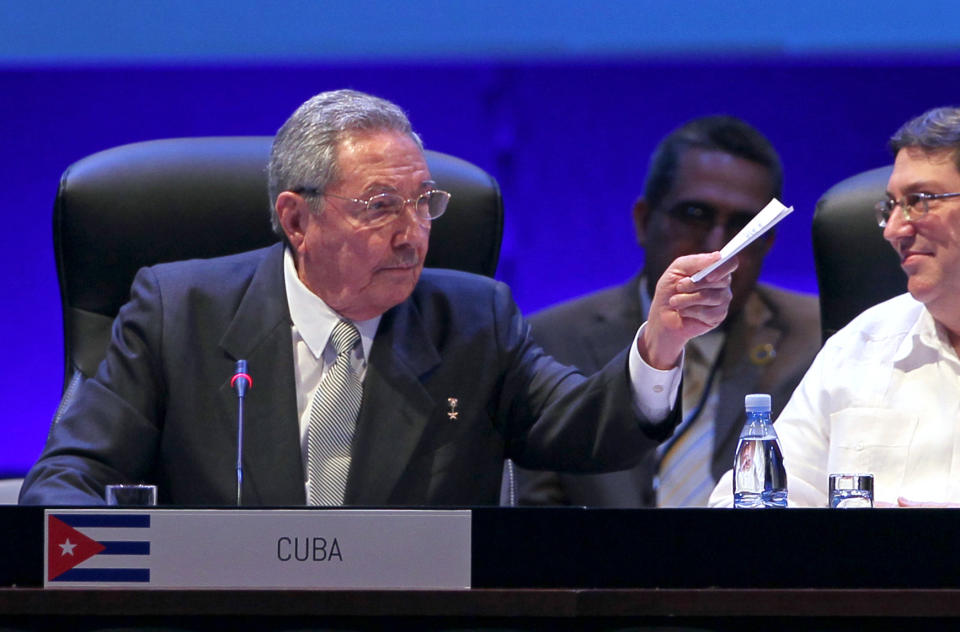 Cuba's President Raul Castro gestures after his opening speech on the second day of the CELAC Summit as his Foreign Minister Bruno Rodriguez looks on in Havana, Cuba, Wednesday, Jan. 29, 2014. Leaders from across Latin America and the Caribbean signed a resolution declaring the region a "zone of peace" on Wednesday, pledging to resolve their disputes as respectful neighbors without the use of arms. (AP Photo/Ismael Francisco, Cubadebate)