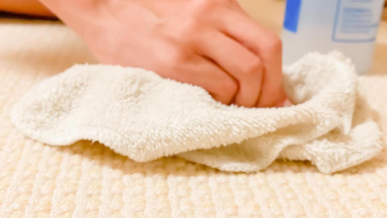 A woman removing stain from carpet