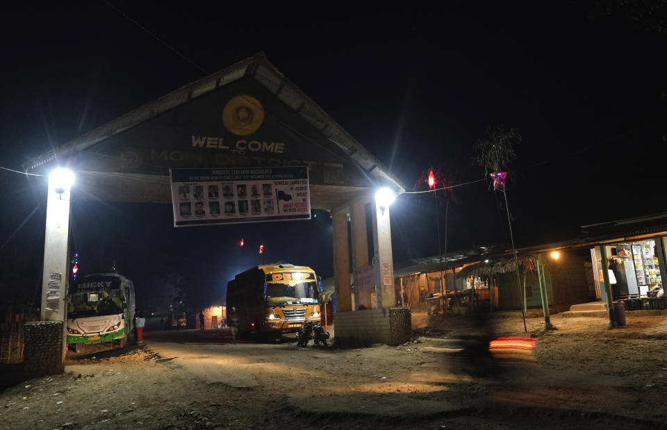 A banner showing portraits of 14 civilians killed by the Indian army hangs at the entrance gate to Mon district, in Tizit, in the northeastern Indian state of Nagaland, Tuesday, Dec. 14, 2021. High up in the hills along India's border with Myanmar, Oting village in the northeastern state of Nagaland is in mourning after more than a dozen people were killed by soldiers. The incident earlier this month is the latest violence to shake the state of Nagaland and has left Oting village reeling in shock and grief for their lost ones. (AP Photo/Yirmiyan Arthur)