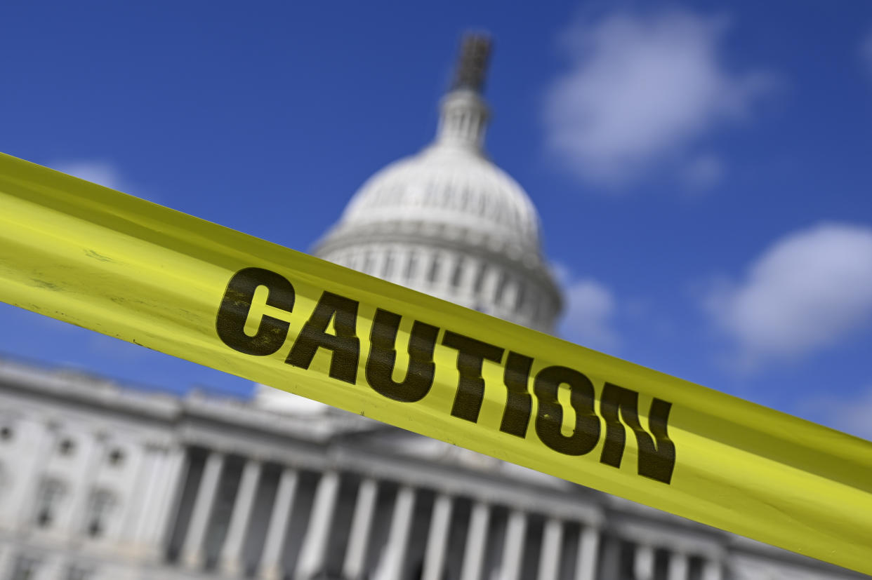  "Caution" tape across the United States Capitol building . 