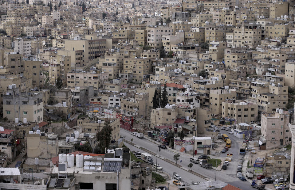 FILE - In this March 21, 2020, file photo, the streets of the Jordanian Capital are empty after the start of a nationwide curfew, amid concerns over the coronavirus pandemic, in Amman, Jordan. The coronavirus outbreak has cratered the economy, causing nearly 25% unemployment and feeding longstanding allegations of corruption and misrule. (AP Photo/Raad Adayleh, File)