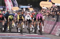 Netherlands' Olva Kooij, 3rd from right, sprints ahead of Italy's Jonathan Milan, right, to win the 9th stage of the of the Giro d'Italia cycling race, from Avezzano to Naples, Italy, Sunday, May 12, 2024. (Massimo Paolone/LaPresse via AP)