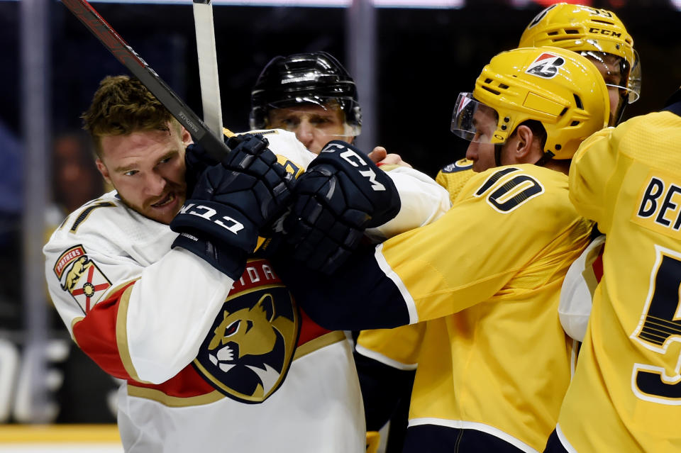 Florida Panthers left wing Jonathan Huberdeau (11) scuffles with Nashville Predators center Colton Sissons (10) during the third period of an NHL hockey game Thursday, March 4, 2021, in Nashville, Tenn. (AP Photo/Mark Zaleski)