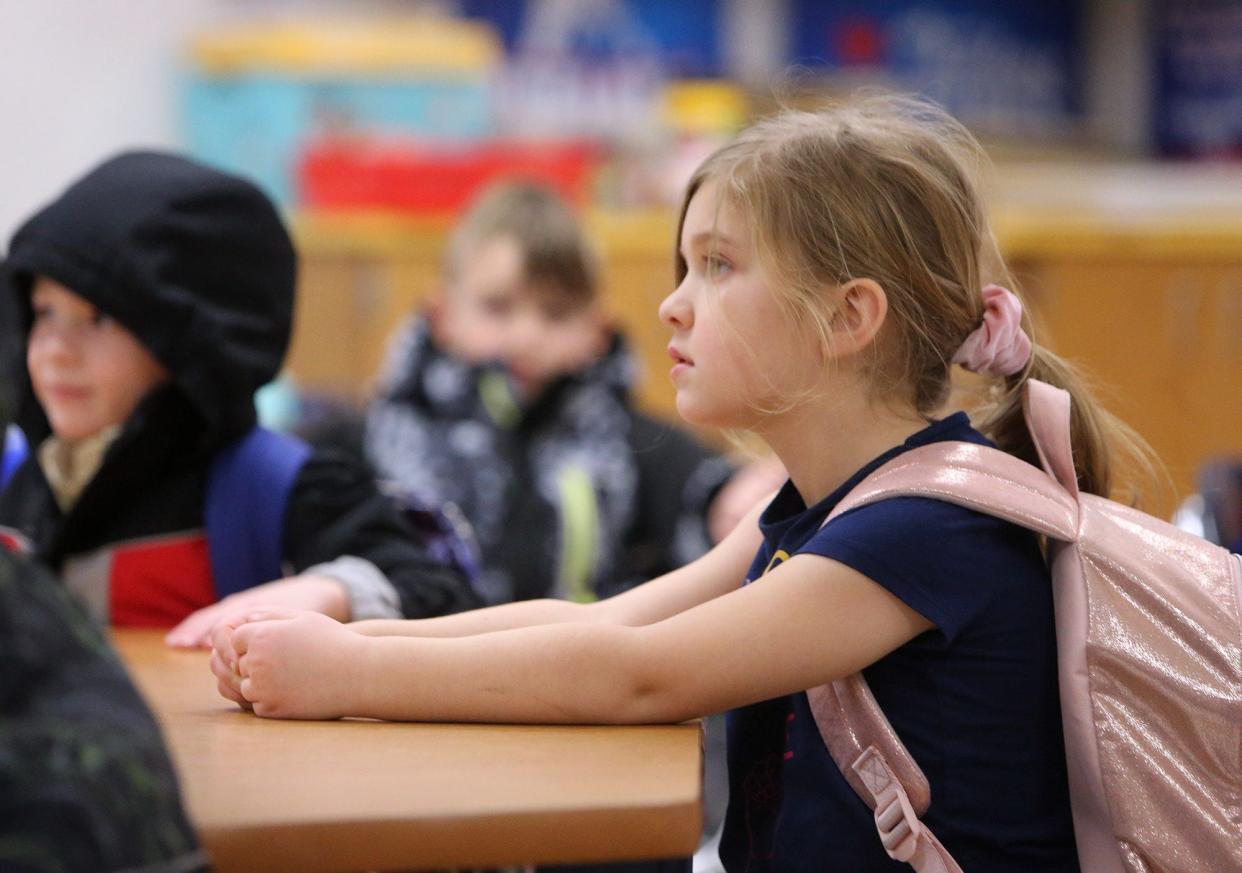 Olivia Crago watches a cartoon before the end of the school day at Tuslaw Elementary School on Friday. Masks are optional for students in the district.