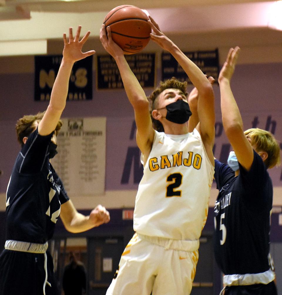 Canajoharie Cougar Aundray Fowler (2) attempts a shot between Central Valley Academy defenders during in first round play Friday at the Little Falls Holiday Classic.