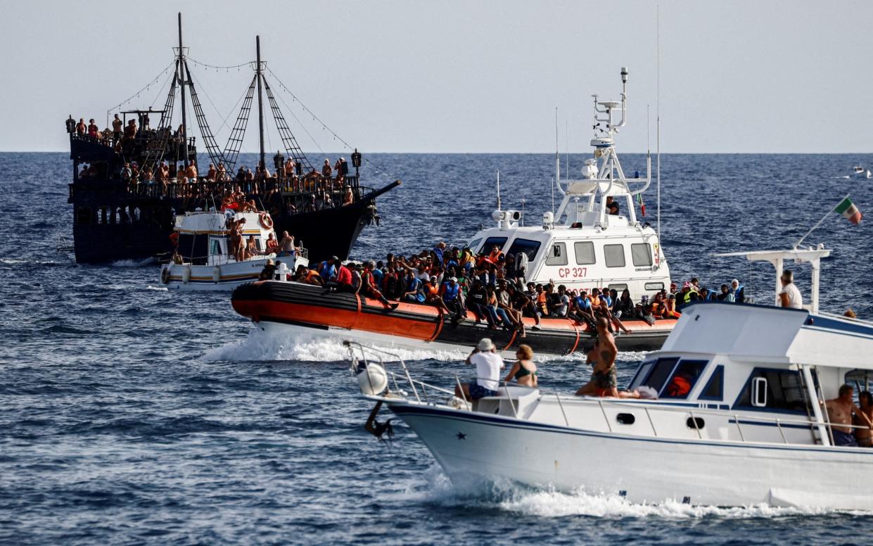 An Italian coast guard vessel carrying migrants rescued at sea arrives at the Sicilian island of Lampedusa