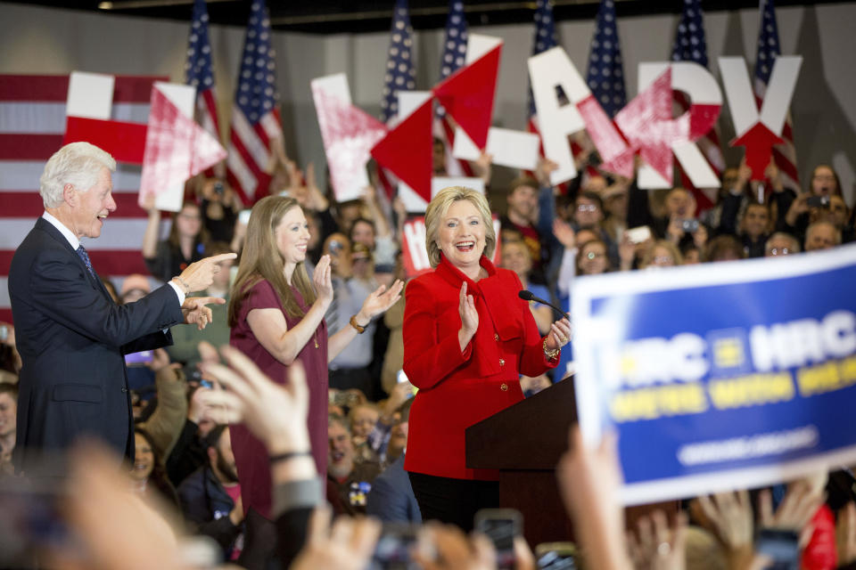 FILE - Democratic presidential candidate Hillary Clinton, right, accompanied by former President Bill Clinton, left, and their daughter Chelsea Clinton, arrives at her caucus night rally in Des Moines, Iowa, Feb. 1, 2016. Iowa's caucuses grew over 50 years to be an entrenched part of U.S. politics. (AP Photo/Andrew Harnik, File)