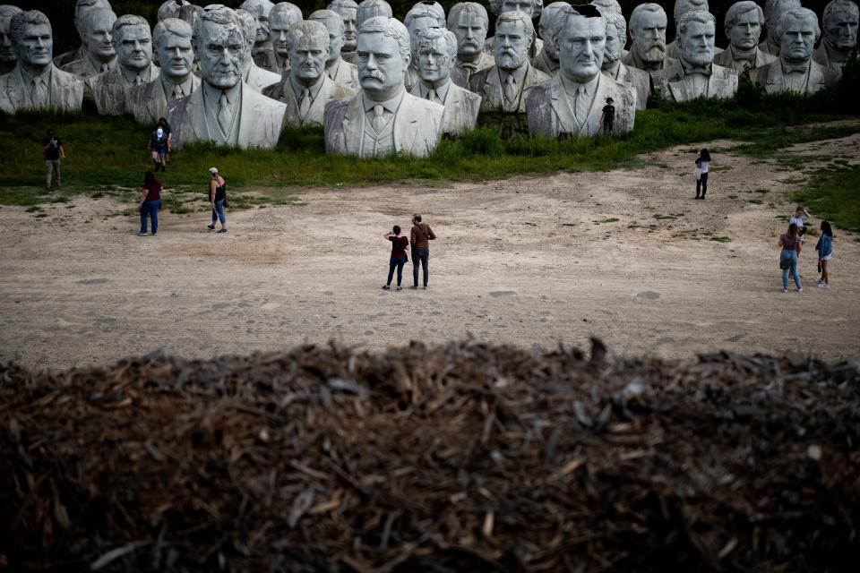 People tour the decaying remains of salvaged busts of former US Presidents August 25, 2019, in Williamsburg, Virginia. (Photo: Brendan Smialowski/AFP/Getty Images)