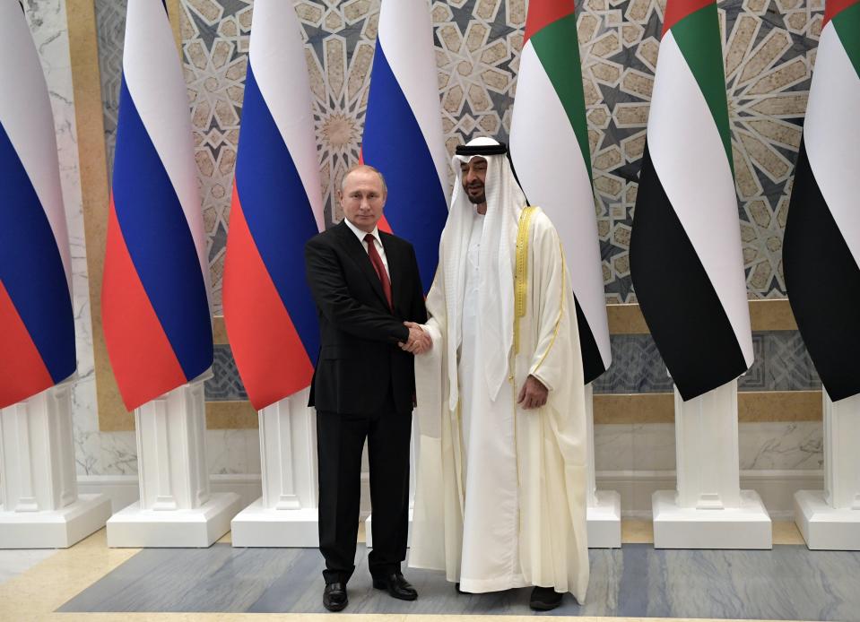 Russian President Vladimir Putin, left, and Abu Dhabi Crown Prince Mohamed bin Zayed al-Nahyan pose for a photo during the official welcome ceremony in Abu Dhabi, United Arab Emirates, Tuesday, Oct. 15, 2019. (Alexei Nikolsky, Sputnik, Kremlin Pool Photo via AP)