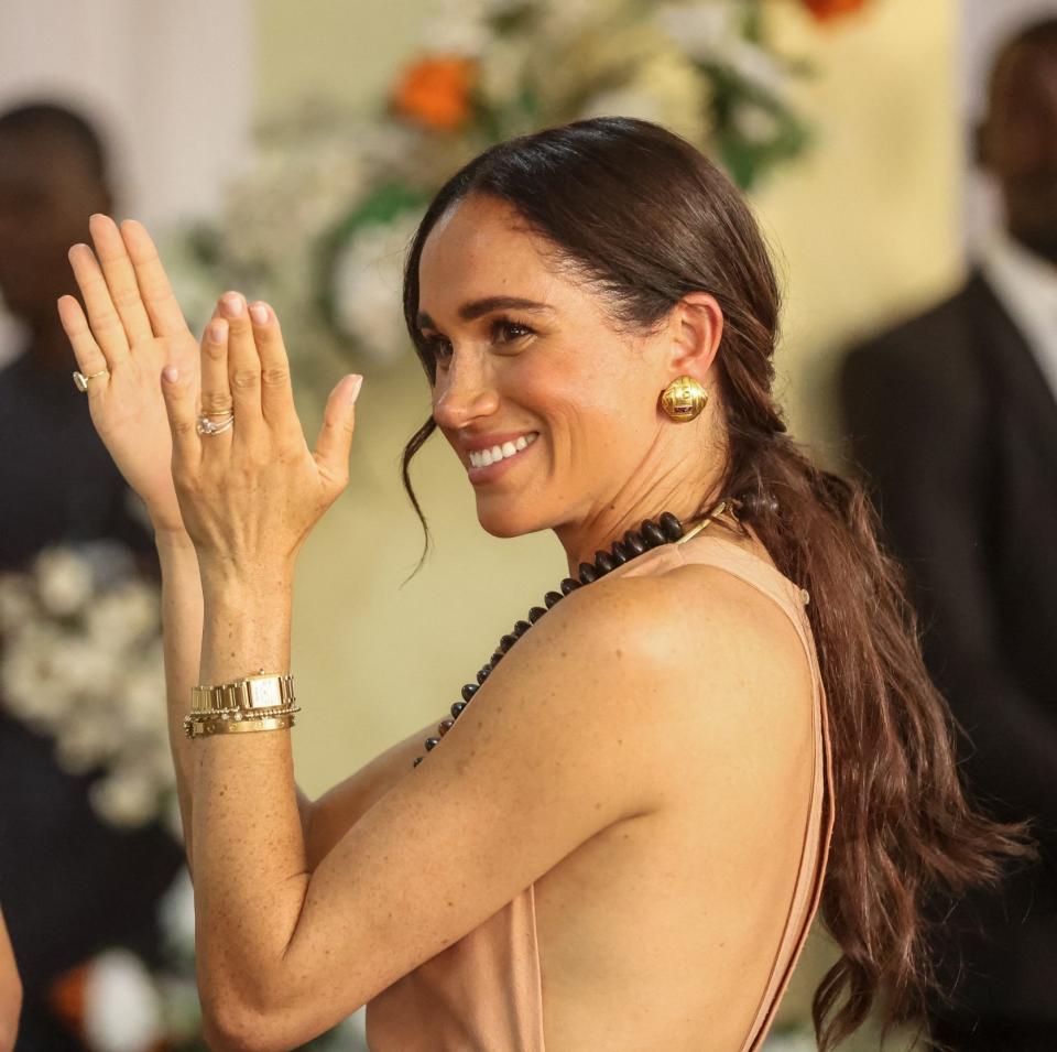 Meghan accessorised her first outfit with her Cartier Tank Francaise watch, Cartier 'Love' bangle and Ariel Gordon diamond tennis bracelet