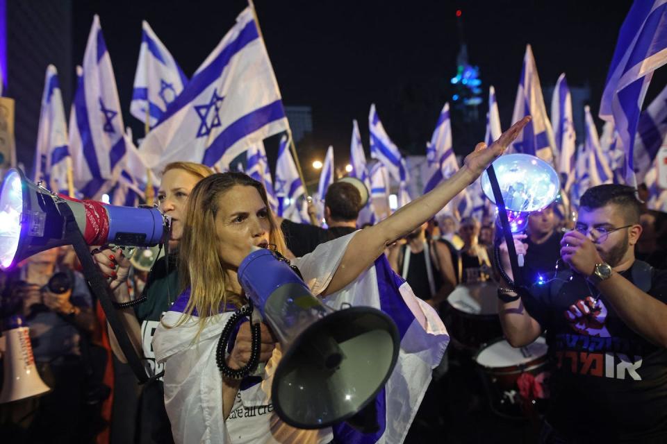 Protesters take part in ongoing demonstrations against proposed judicial reforms in Tel Aviv on April 8, 2023. <a href="https://media.gettyimages.com/id/1250898554/photo/israel-politics-protest-judiciary.jpg?s=612x612&w=gi&k=20&c=vZSiJODDKfXS5vGmuQEjAaeUAIBIyvB3niDZRDSThqk=" rel="nofollow noopener" target="_blank" data-ylk="slk:Gil Cohen-Magen/AFP via Getty Images;elm:context_link;itc:0;sec:content-canvas" class="link ">Gil Cohen-Magen/AFP via Getty Images</a>