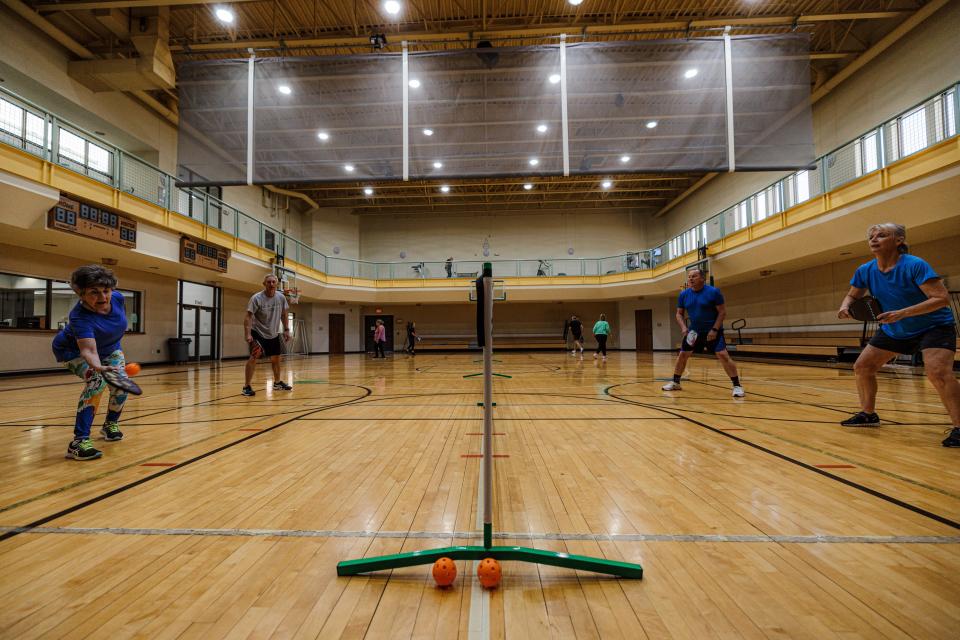 Pickleball players move quickly to the net to play defense.