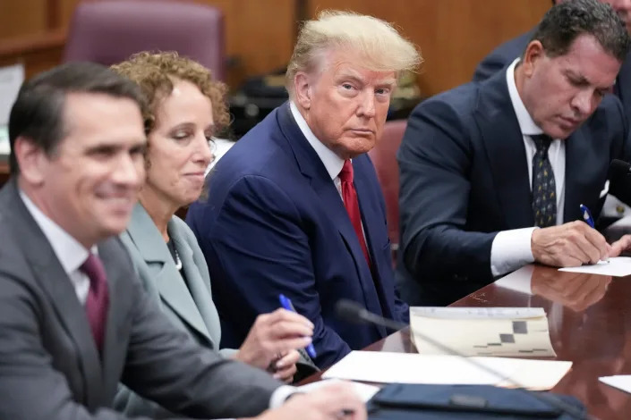 Flanked by attorneys, former U.S. President Donald Trump appears in the courtroom for his arraignment proceeding at Manhattan Criminal Court on April 4, 2023, in New York City.