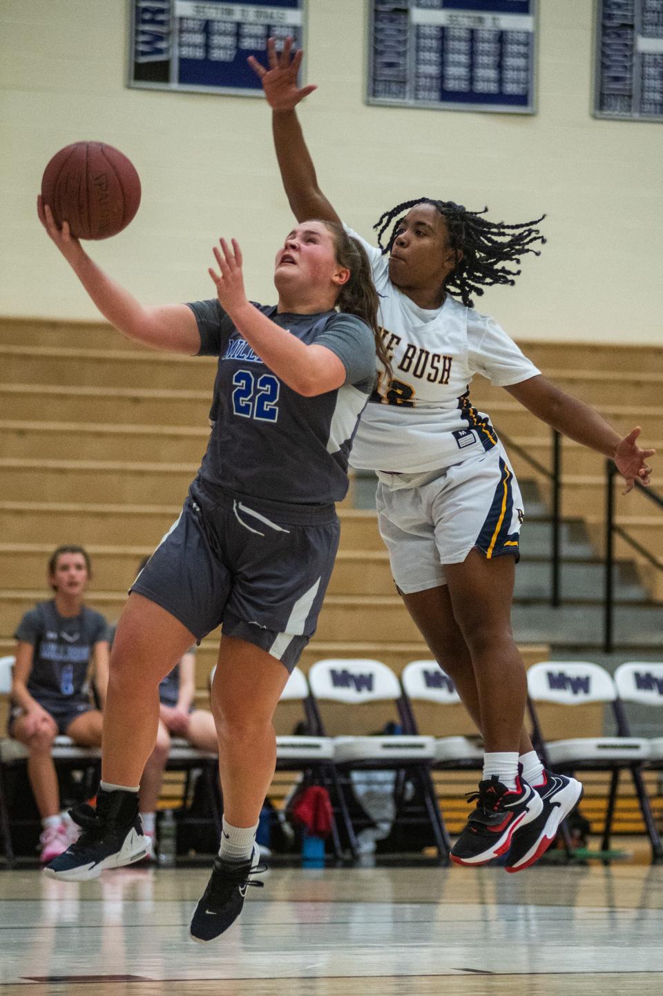 Millbrook's Ella Wilson, left, drove for a layup against Pine Bush during a January game. Wilson just returned from injury and scored 16 points as the Blazers won a regional final on Saturday.