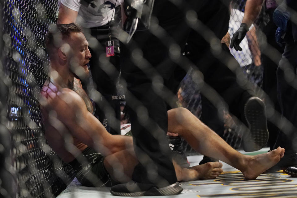 Conor McGregor receives attention after suffering an injury while fighting Dustin Poirier in a UFC 264 lightweight mixed martial arts bout Saturday, July 10, 2021, in Las Vegas. (AP Photo/John Locher)