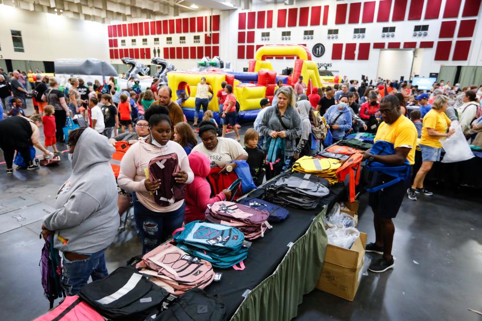 Parents and students pick up free backpacks during the Springfield Public School Back To School Bash at the Springfield Expo Center on Saturday, July 30, 2022.
