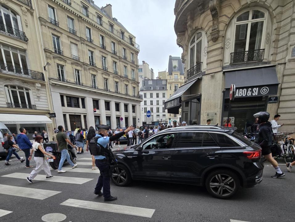 A police officer directs a driver to make a U-turn ahead of the Opening Ceremony in Paris.