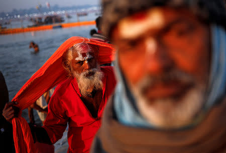 Sadhus or Hindu holy men leave after taking a holy dip at Sangam, the confluence of the Ganges, Yamuna and Saraswati rivers, during "Kumbh Mela", or the Pitcher Festival, in Prayagraj, previously known as Allahabad, India, January 16, 2019. REUTERS/Danish Siddiqui