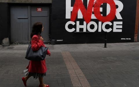  A woman walks past a new Pro-Choice mural by a graffiti artist collective called 'Subset' ahead of a 25th May referendum on abortion law, in Dublin - Credit:  CLODAGH KILCOYNE/ REUTERS