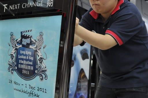 A cinema worker is seen placing the poster for the 22nd Hong Kong Lesbian and Gay Film Festival (HKLGFF) into a frame, on November 18. The HKLGFF offers new work from Malaysia, Thailand and Vietnam and throwing a light on the challenges sexual minorities face around Asia