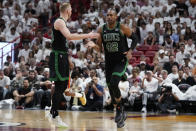 Boston Celtics center Al Horford (42) and forward Sam Hauser congratulate each other after a play during the second half of Game 3 of an NBA basketball first-round playoff series against the Miami Heat, Saturday, April 27, 2024, in Miami. (AP Photo/Wilfredo Lee)