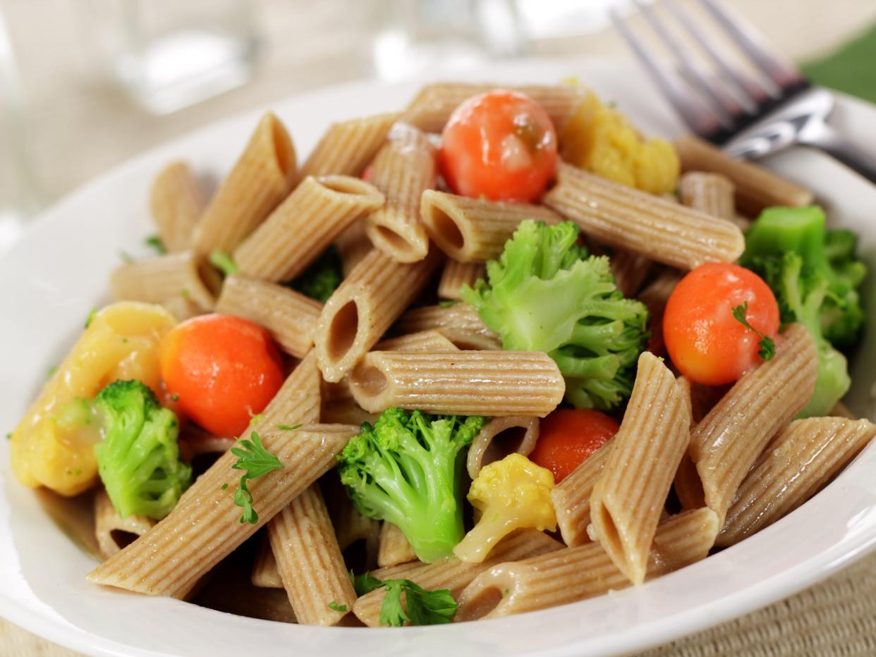 Lunch consisting of whole wheat pasta and vegetables - stock photo