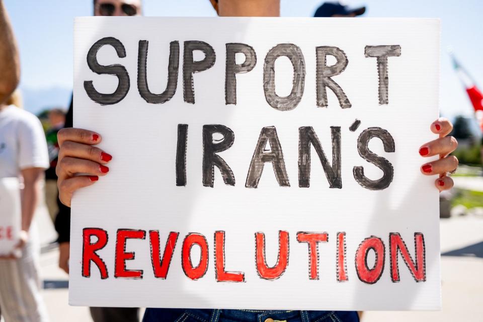 A woman holds a sign during a protest against the Iranian regime at the Capitol in Salt Lake City on Saturday. The protest was held on the one-year anniversary of the death of Mahsa Amini, who was arrested by Iran’s morality police for allegedly violating the country’s strict dress code for women.
