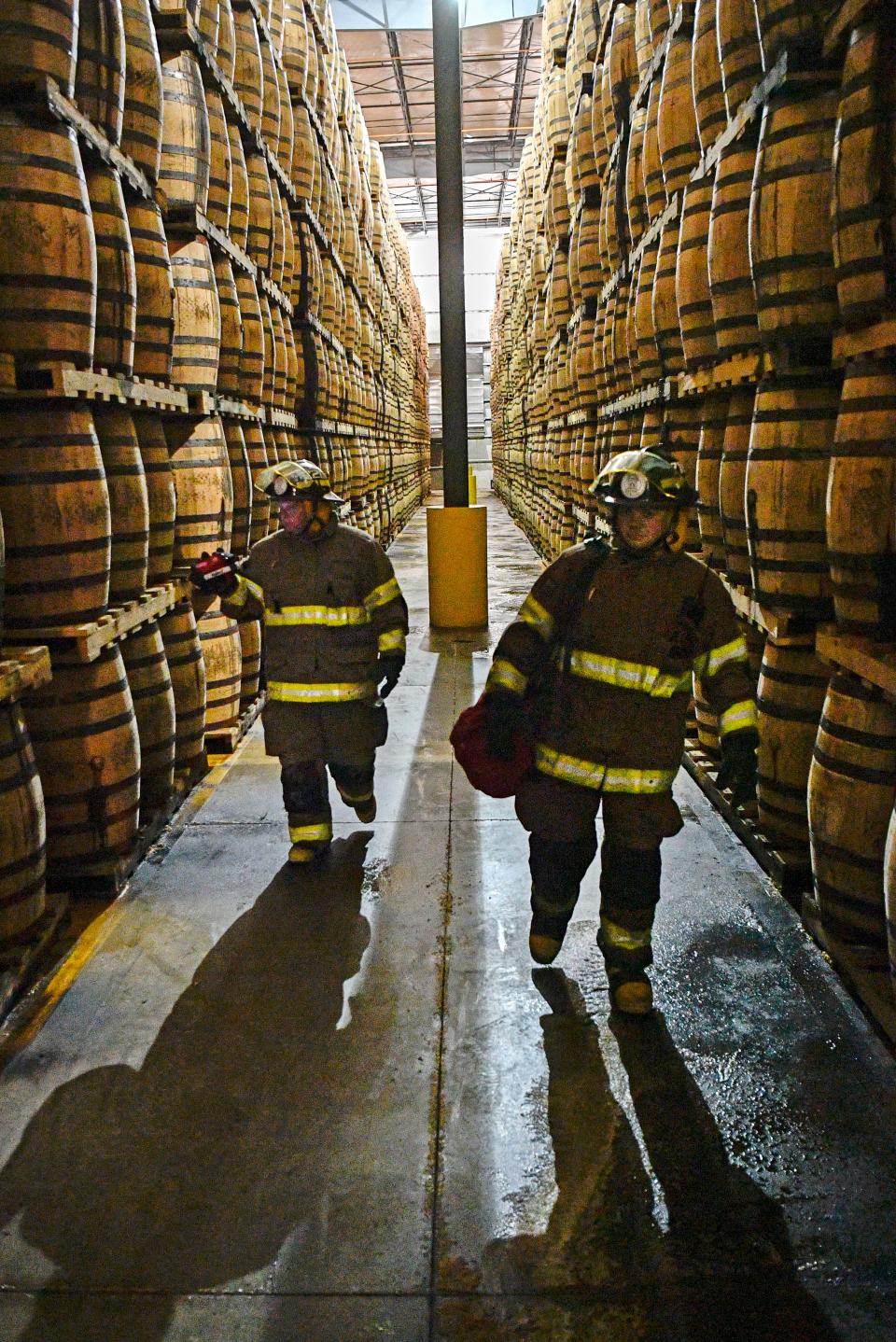 Caleb Barnett and Cody Cashion familiarize themselves with a barrelhouse during a Jack Daniel's Volunteer Fire Brigade training exercise Monday, July 22, 2019, in Lynchburg, Tenn.