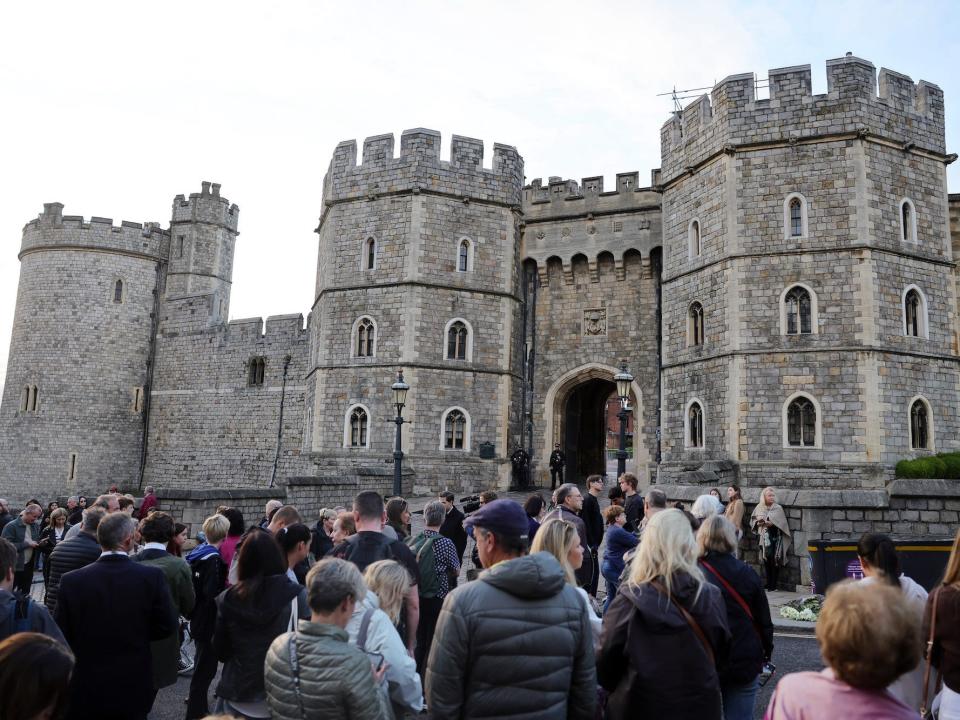 People gather in front of Windsor Castle following Queen Elizabeth II's death.