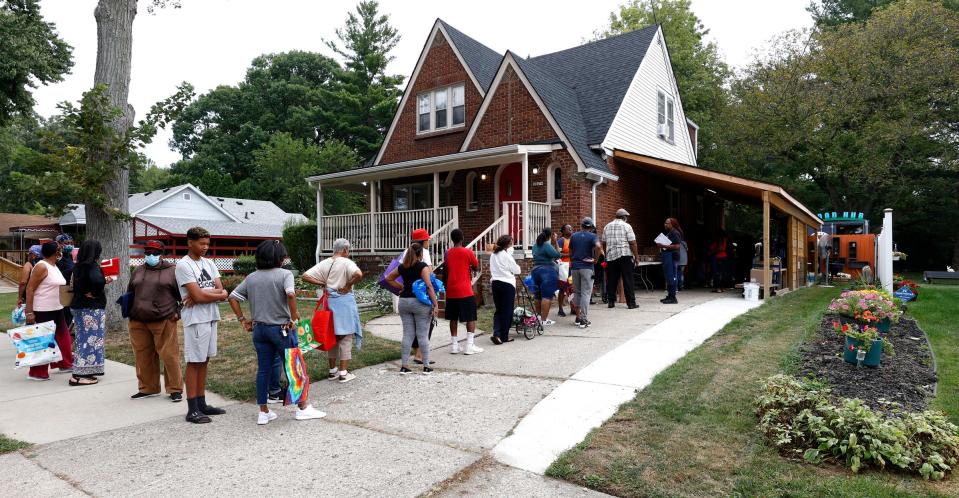 People line up before the opening of a weekly food giveaway at SDM2 Project Education in Detroit on Tuesday, Sept. 20, 2022. Items like fresh fruit, frozen meats, salads and sandwiches are given out at the home the organization uses for meetings and events.