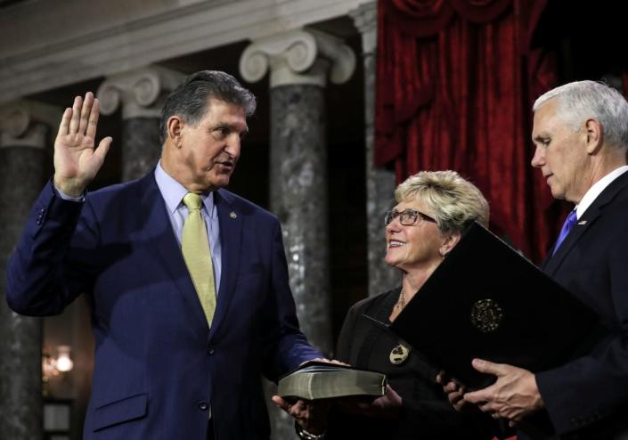<div class="inline-image__caption"><p>Joe Manchin is flanked his wife Gayle as he is sworn in by Vice President Mike Pence on Jan. 3, 2019. </p></div> <div class="inline-image__credit">Alex Edelman/AFP via Getty</div>