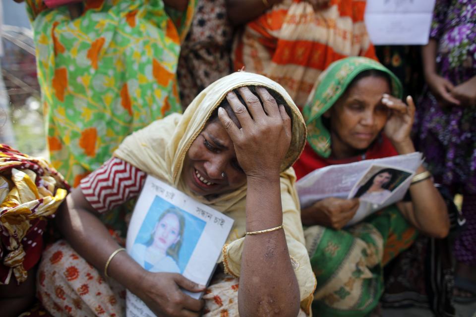 A relative of a garment worker, who is still missing after the Rana Plaza building collapse, cries during a protest in front of the site in Savar