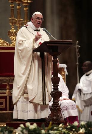 Pope Francis reads his homily during the Christmas night mass in the Saint Peter's Basilica at the Vatican