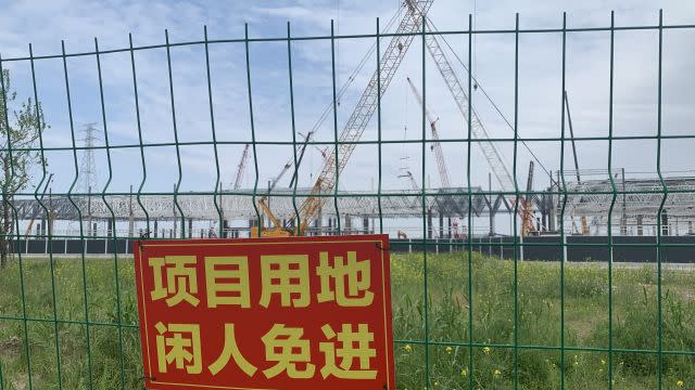 A sign on the fence of Gigafactory 3 says no admittance.