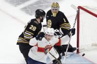 Florida Panthers' Anton Lundell (15) celebrates a goal by Vladimir Tarasenko, in front of Boston Bruins' Derek Forbort (28) and Jeremy Swayman (1) during the second period in Game 3 of an NHL hockey Stanley Cup second-round playoff series, Friday, May 10, 2024, in Boston. (AP Photo/Michael Dwyer)