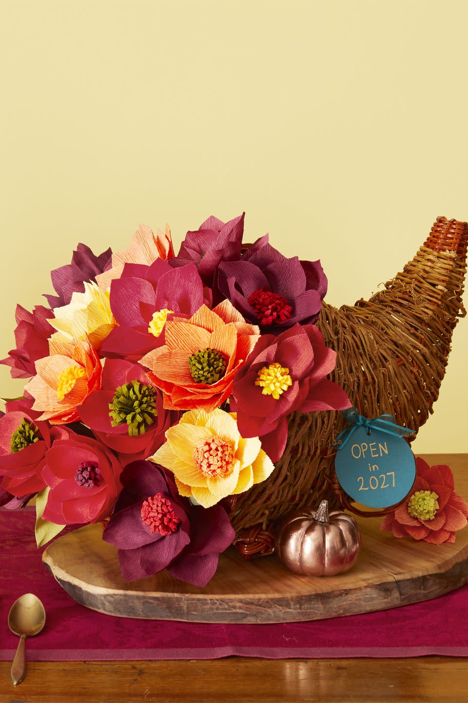 <p>Capture a year's worth of family milestones and memories with a cornucopia centerpiece. Tuck a time capsule (see next slide) into the bottom of the basket and top with a bouquet of handmade crepe-paper flowers, pushing in a disc of floral foam first to keep the stems in place.</p><p><strong>What you'll need: </strong>Cornucopia basket ($16, <a rel="nofollow noopener" href="https://www.amazon.com/Import-Designer-Cornucopia-12-Longv/dp/B00LDW4LG8" target="_blank" data-ylk="slk:amazon.com;elm:context_link;itc:0;sec:content-canvas" class="link ">amazon.com</a>); Assorted tissue paper ($3, <a rel="nofollow noopener" href="http://www.michaels.com/celebrate-it-solid-tissue-assorted-primary/10275066.html" target="_blank" data-ylk="slk:michaels.com;elm:context_link;itc:0;sec:content-canvas" class="link ">michaels.com</a>); Floral foam disc ($13, <a rel="nofollow noopener" href="https://www.amazon.com/FloraCraft-Styrofoam-Disc-Inch-White/dp/B00OLOYSCC" target="_blank" data-ylk="slk:amazon.com;elm:context_link;itc:0;sec:content-canvas" class="link ">amazon.com</a>)</p>