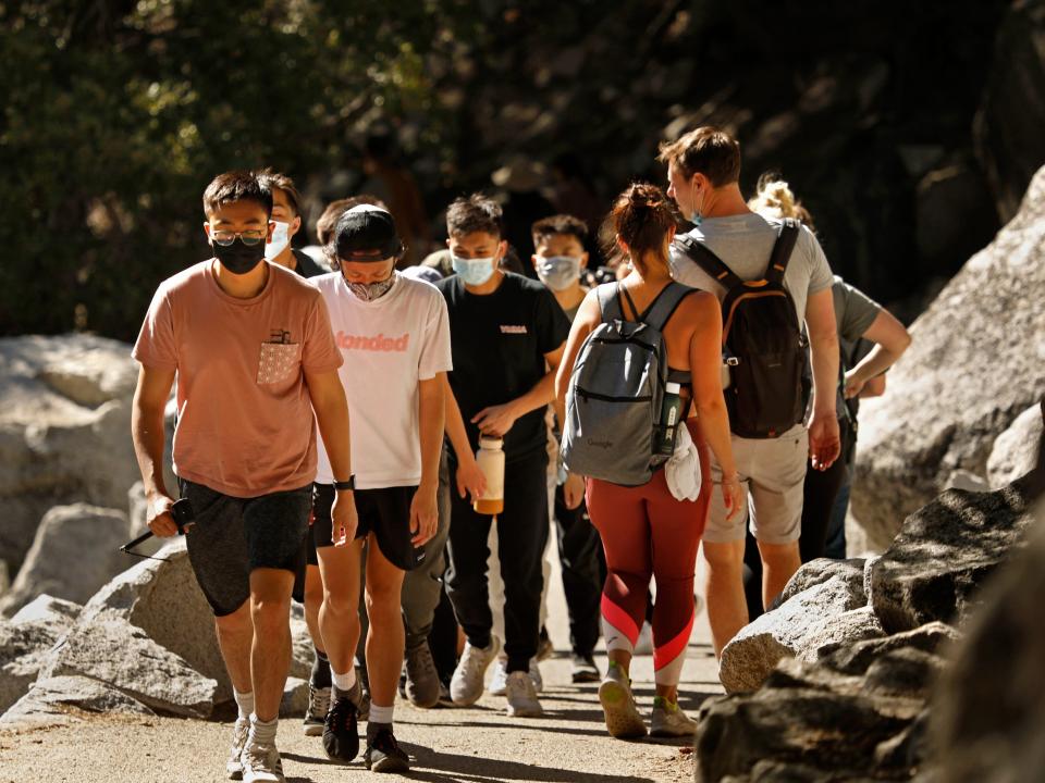 Hikers make their way along Mist Trail which leads to Vernal Fall on Sunday, April 18, 2021, some wearing masks, and some not.