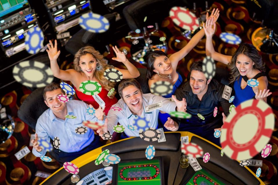 Gamblers at a casino table throwing chips in the air.