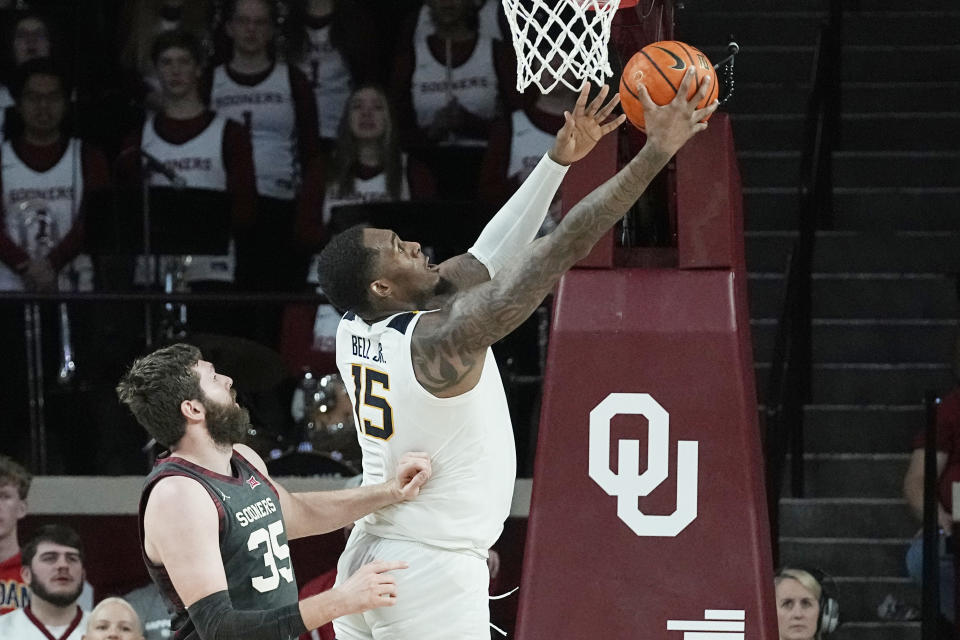 West Virginia forward Jimmy Bell Jr. (15) shoots in front of Oklahoma forward Tanner Groves (35) in the second half of an NCAA college basketball game Saturday, Jan. 14, 2023, in Norman, Okla. (AP Photo/Sue Ogrocki)