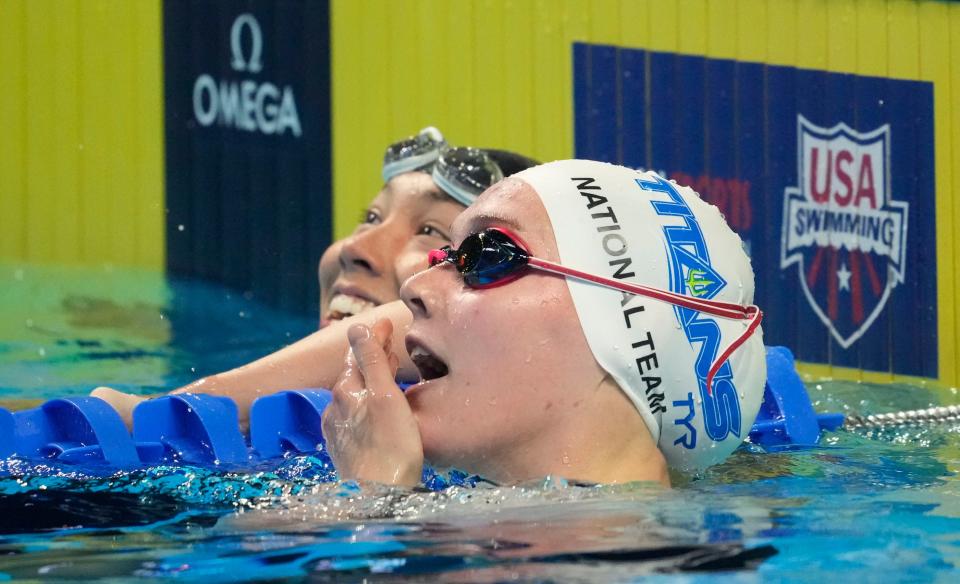 Torri Huske (left) and Claire Curzan (right) react after the women's 100m butterfly final during the U.S. Olympic Team Trials Swimming competition. The two teenage girls placed first and second, respectively.