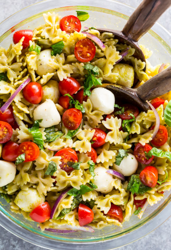 <p>Baker by Nature</p><p>This 20-minute tomato, basil, and mozzarella pasta salad is fresh, fast, and so flavorful! The perfect quick and easy summer pasta salad recipe.</p><p><strong>Get the recipe: <a href="https://bakerbynature.com/garlicky-tomato-basil-pasta-salad/" rel="nofollow noopener" target="_blank" data-ylk="slk:Garlicky Tomato Basil Pasta Salad;elm:context_link;itc:0;sec:content-canvas" class="link ">Garlicky Tomato Basil Pasta Salad</a></strong></p>