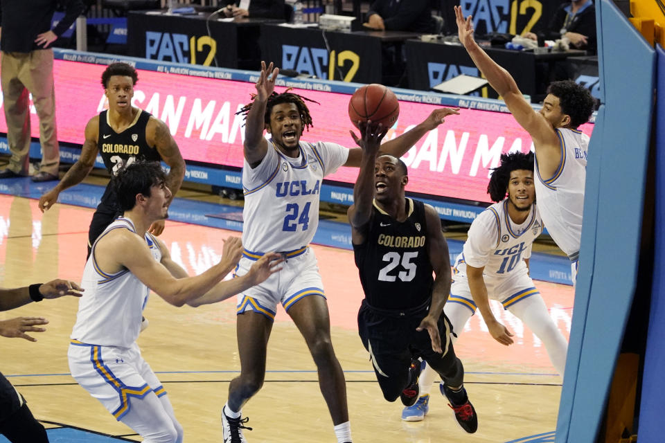 Colorado guard McKinley Wright IV (25) drives to the basket against UCLA during the first half of an NCAA college basketball game Saturday, Jan. 2, 2021, in Los Angeles. (AP Photo/Marcio Jose Sanchez)