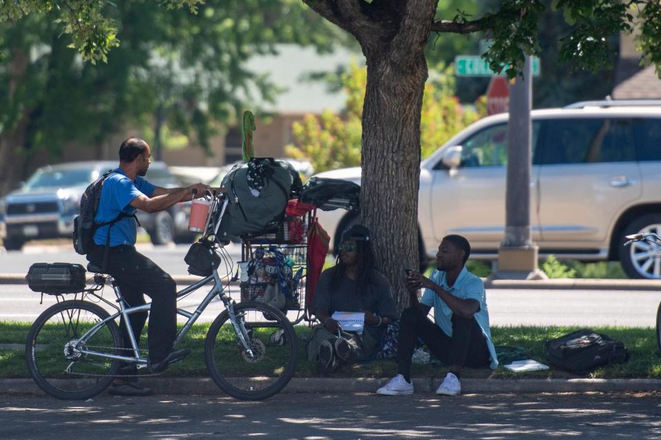 A group of people hang out at the McDonald's parking lot off the 2400 block of South College Avenue in Fort Collins on Tuesday.