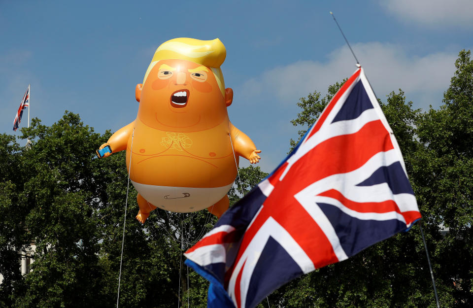 Demonstrators float a blimp portraying President Donald Trump, next to a Union Flag above Parliament Square, during the visit by Trump and First Lady Melania Trump in London on July 13, 2018.&nbsp;