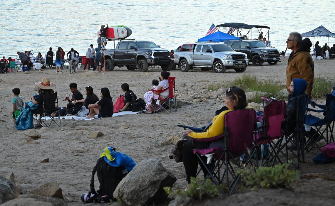 Families gather along the shoreline for the 2022 Shaver Lake fireworks show Saturday, July 2, 2022 at Shaver Lake. A boat parade started at 6pm and the fireworks which began at dark were visible along the shore for thousands who came to celebrate.