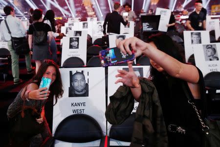 Journalists walk through cardboard cutouts showing where attendees will sit for the upcoming 2016 MTV VMA awards in New York, August 25, 2016. REUTERS/Lucas Jackson