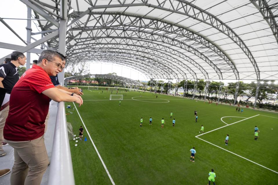 Edwin Tong (left), Minister for Culture, Community and Youth, watches the Singapore national age-group teams training at the new Kallang Football Hub. (PHOTO: Singapore Sports Hub)