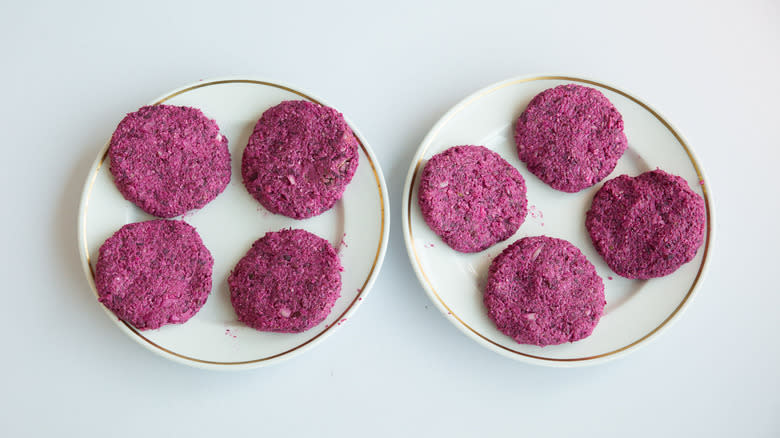 plates with uncooked beet burgers 