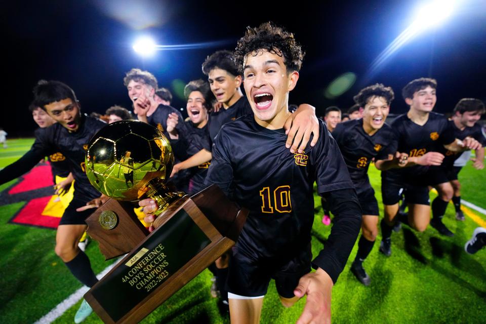 Salpointe Catholic senior Nico Valenzuela runs off the pitch with his teammates carrying the 4A Championship Trophy after they beat Saguaro 4-1 at Glendale High School on Feb. 24, 2023, in Glendale.